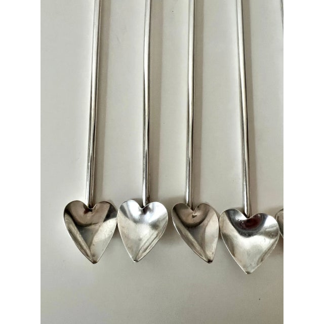 A set of 4 (one sold) Sterling tea spoons with a heart shaped scoop. The set are a compliment to any bar or place setting...