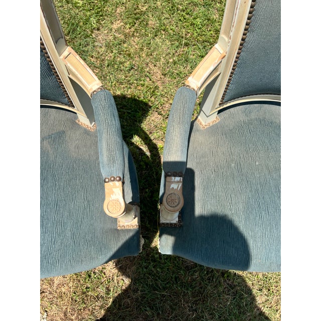 Pair of 19th Century Louis XVI Armchairs featuring hand-carved and painted wood frames with elegant square backs, fluted...