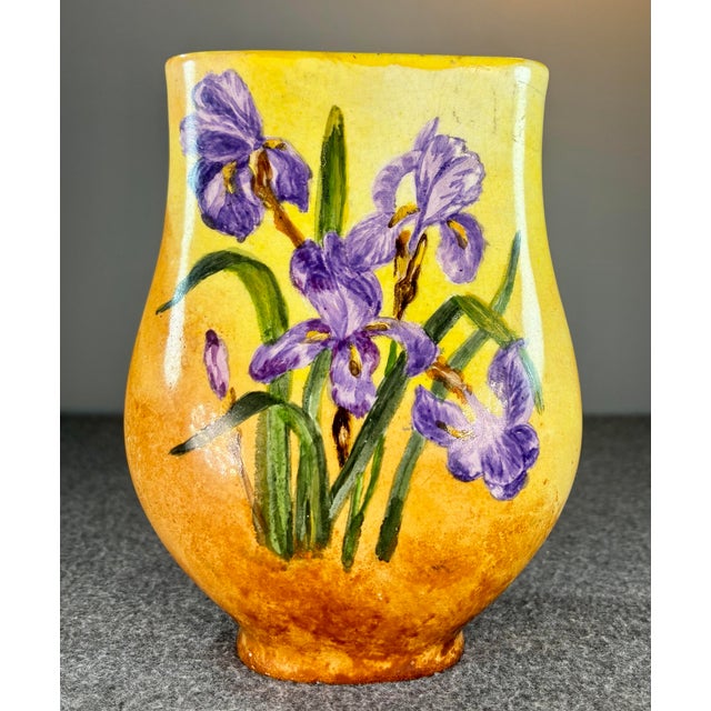 Orange colored background with purple and yellow flowers and a sleek form design. Marked to bottom I.V.W for Ivory White...