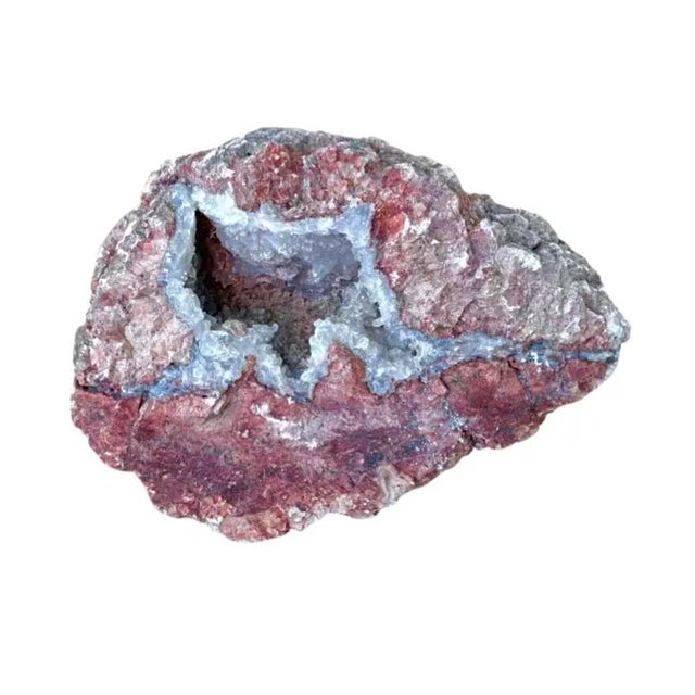 Natural Quartz Geode in Iron-Stained Matrix. Quartz crystals developed over millions of years inside a hollow cavity from...