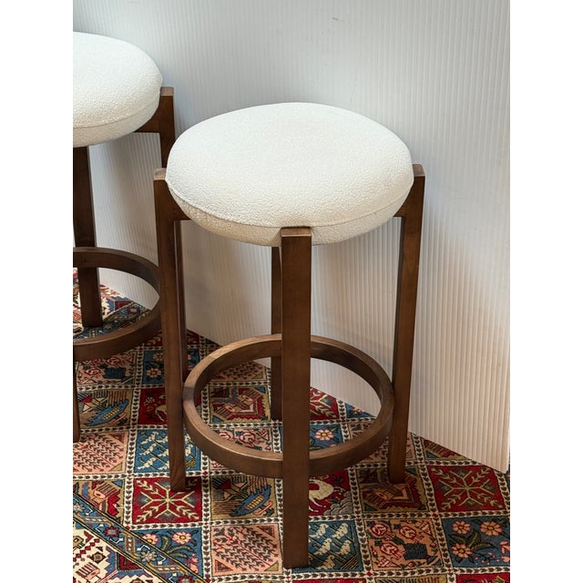 Design Plus Gallery presents a Pair of Dark Walnut Wood and Boucle Counter Stools. The stools will bring a refined...