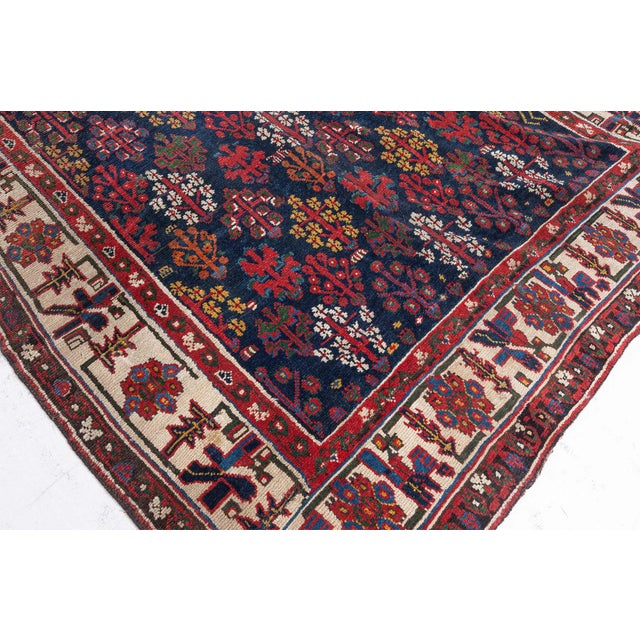 An antique North West Persian Rug. Late 19th Century.Tribal in feeling with abstract and geometric shapes arranged in a...