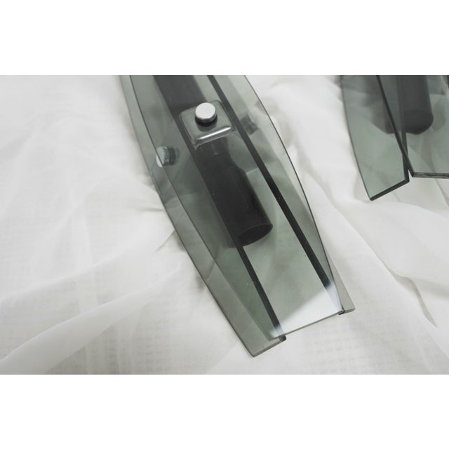 Pair of sculptural Italian glass wall sconces with faceted smoked grey fume glass. An elegant pair of vintage Italian...