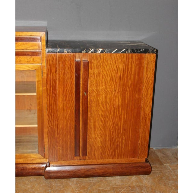 Art Deco period mahogany sideboard, opening with two asymmetrical double doors, one glazed door and two drawers,...