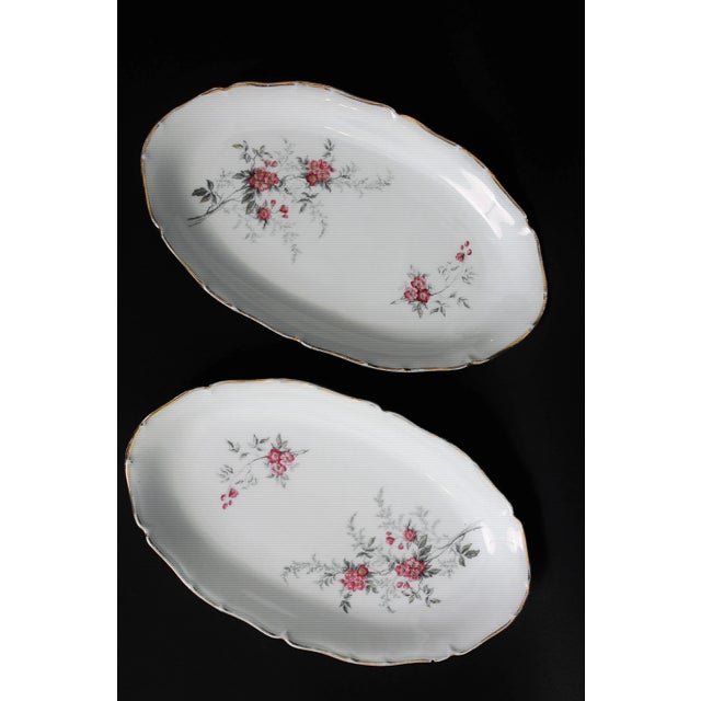 Beautiful Limoges porcelain tableware with floral decoration and gilding comprising 56 pieces: 24 flat plates, 10 small...