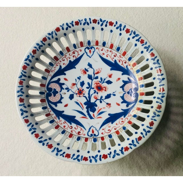 A showpiece from the nineteenth century, this French porcelain compote commands attention with its pierced reticulated rim...