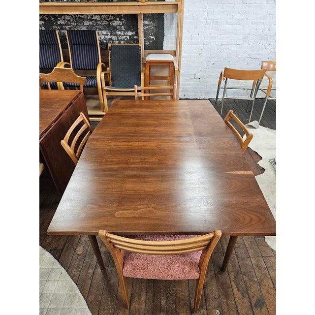 Beautiful Mid-Century Modern Walnut Dining Table that has been refinished. Crafted with a rich walnut finish, highlighting...