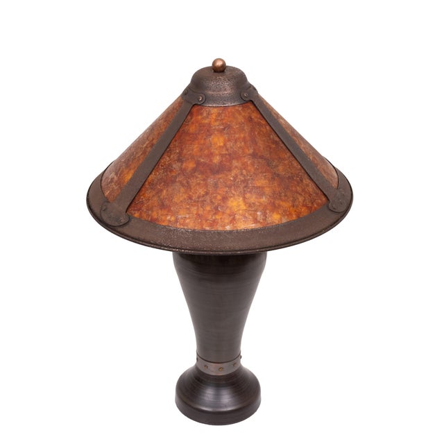 Very nice Arts and Craft Table lamp. Bronze base, comes with a Mica shade. A vintage Arts & Crafts table lamp in the style...