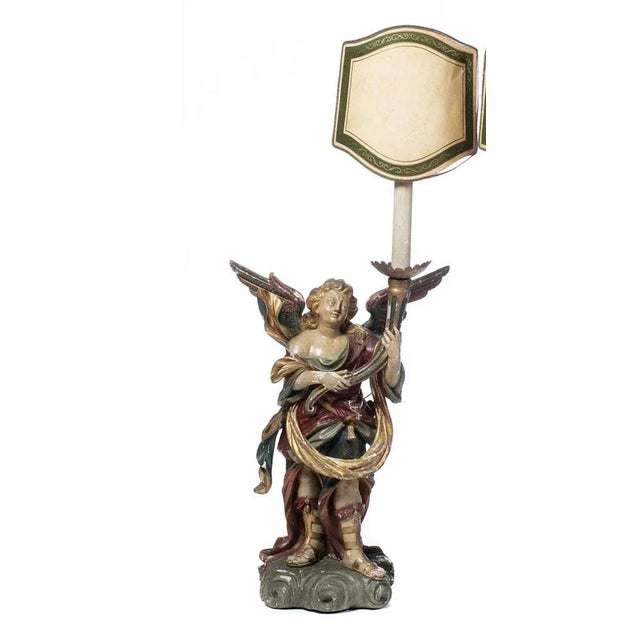 Pair of Portuguese Candeliary Seraphins 19th century in polychrome and gilded wood. The figures are represented standing,...