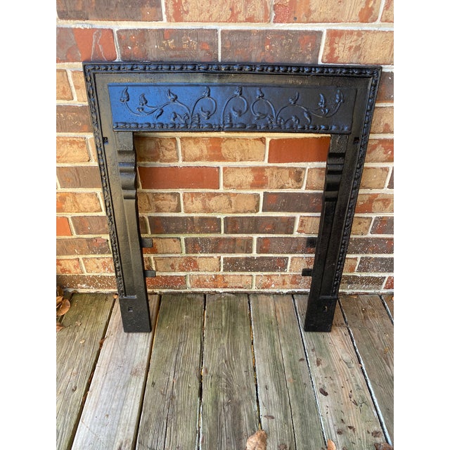 This is a stunning antique cast iron fireplace surround made in circa 1920's/1930's. This black fireplace surround is in...