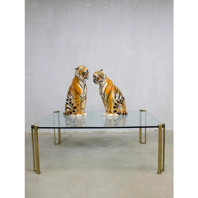 This design by Peter Ghyczy combines a thick heavy glass top and a brass frame.