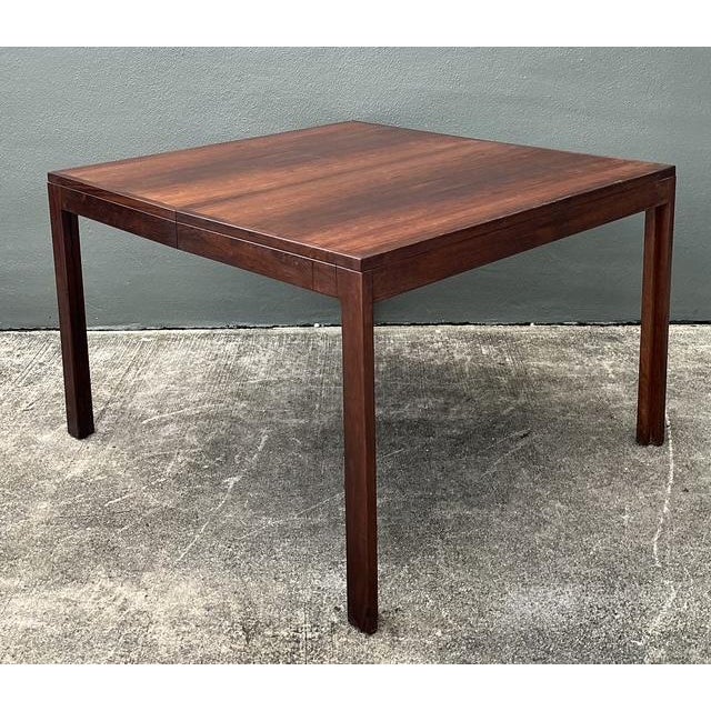 This Mid-Century Modern dining table is a masterclass in Danish functionality and minimalist aesthetic. Crafted from rich,...