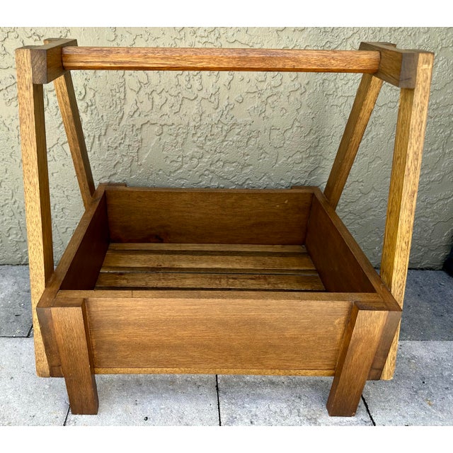 Vintage mid 1900s handmade solid wood box with handle. Slatted bottom with legs. Measures 19 1/2” wide x 16” deep x 19” tall.