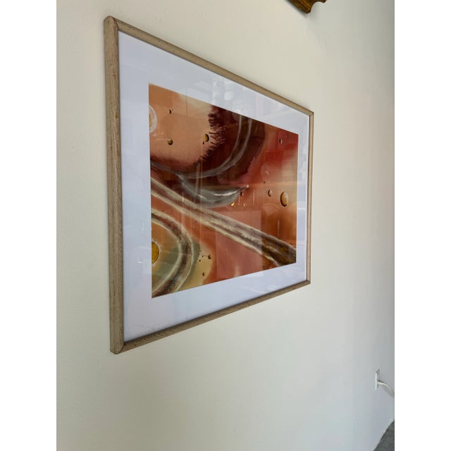 This vintage painting, rendered in warm hues of red, brown, and orange, explores the abstract beauty of outer space....