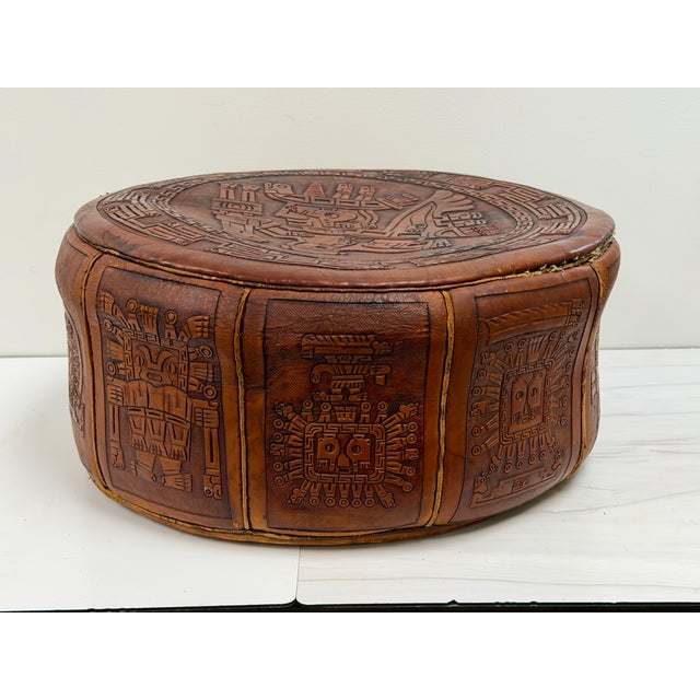 Hand-tooled vintage leather ottoman or pouf from Peru, featuring magnificent embossed pre-Columbian or Incan-inspired...