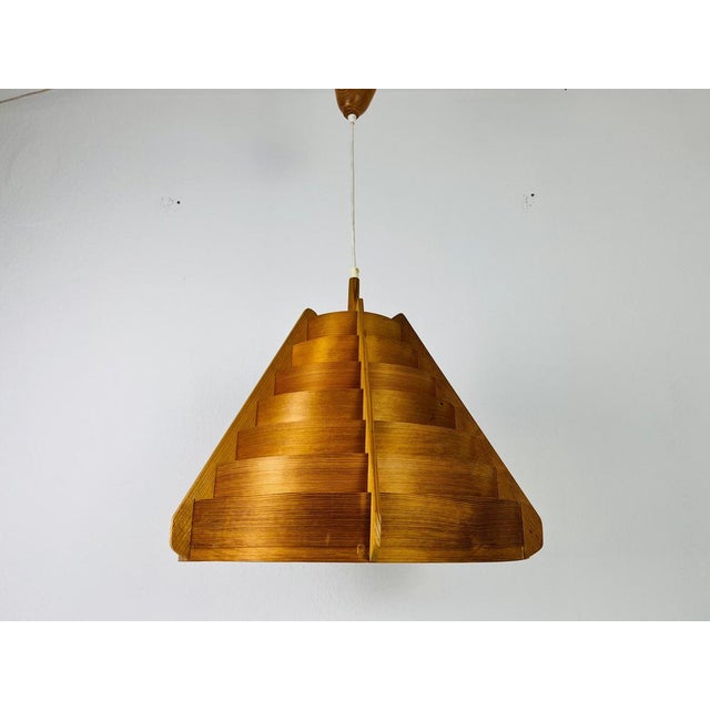 A wooden pendant lamp by hans-agne jakobsson made in the 1960s. The body of the lamp is wood. The lamp has a beautiful...