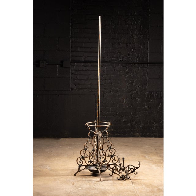 This exquisite turn of the century garment rack features beautiful cast scrollwork on japanned copper. This antique coat...