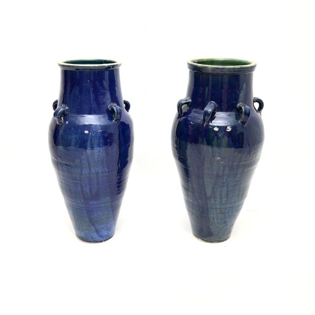 A gorgeous matched pair of large floor standing vintage blue ceramic vases. They were likely made in England, and they...