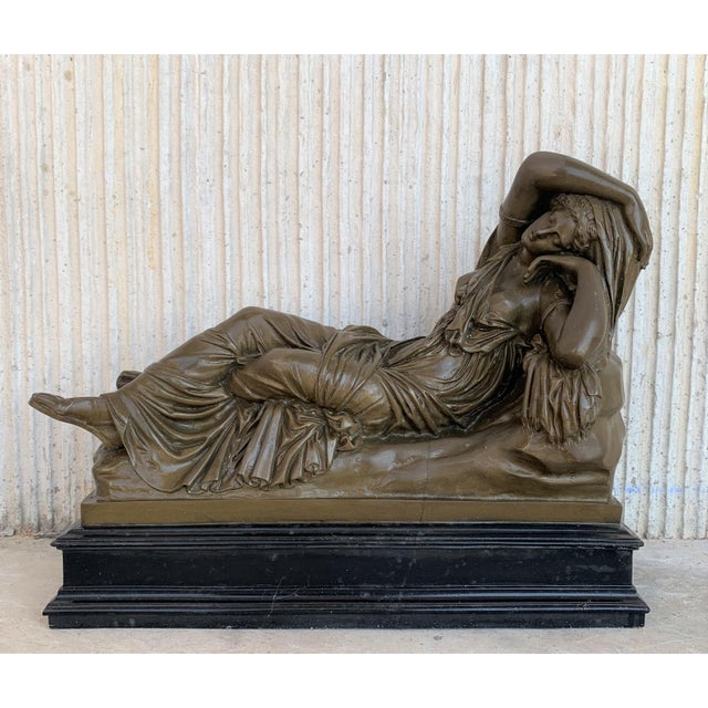 Italian bronze Tuscany neoclassical style sculpture featuring a relaxed woman in black base.