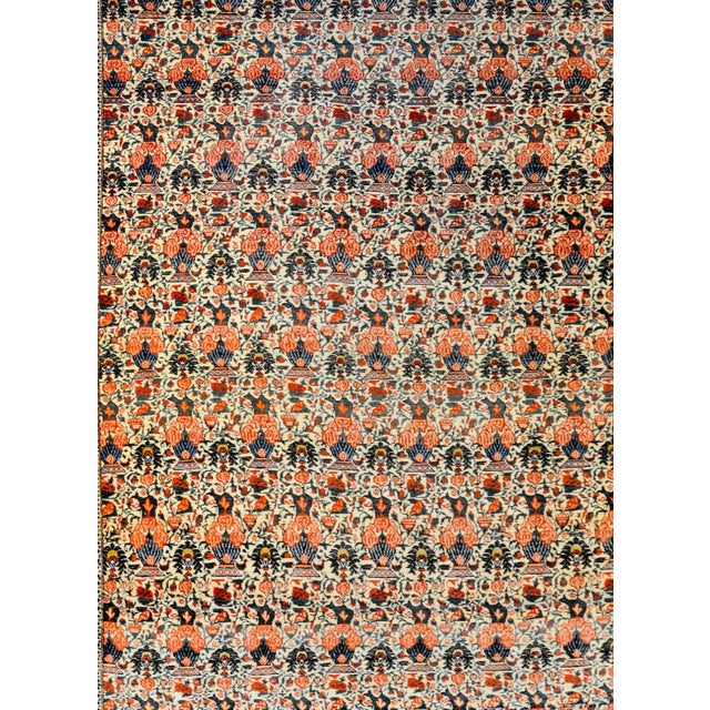 An amazing early 20th century Persian Tehran rug with an all-over pattern of potted flowering plants amidst a field of...