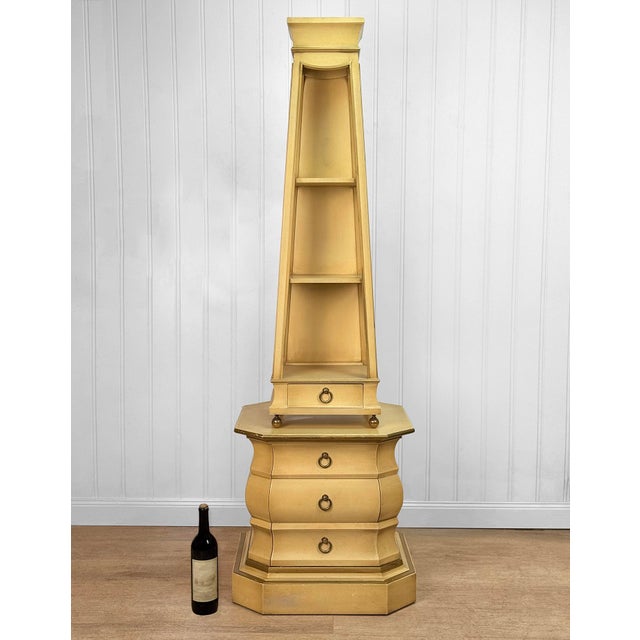 A 1970's Hollywood Regency Obelisk Etagere Shelf Solid Wood Construction with an Original Pale Yellow Finish & Gold...