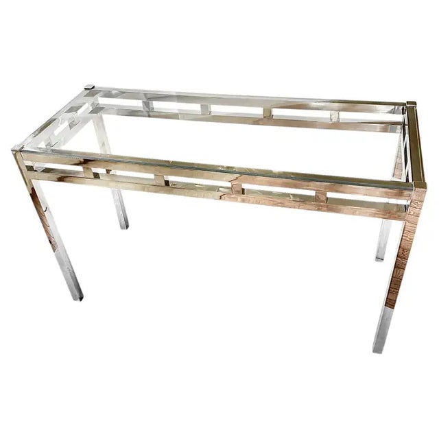 Mid-Century Modern glass and polished chrome console table in the style of Willy Rizzo. This sleek modern console features...