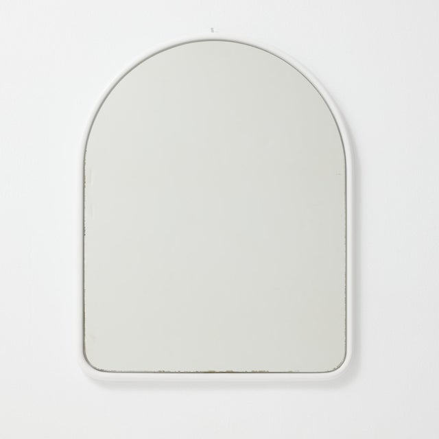 A sleek and timeless French arched wall mirror from the 1970s, featuring a clean white metal frame and a graceful curved...