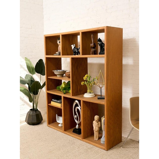 A substantial vintage bookcase with a wonderfully architectural open-grid design and warm natural oak finish. The...