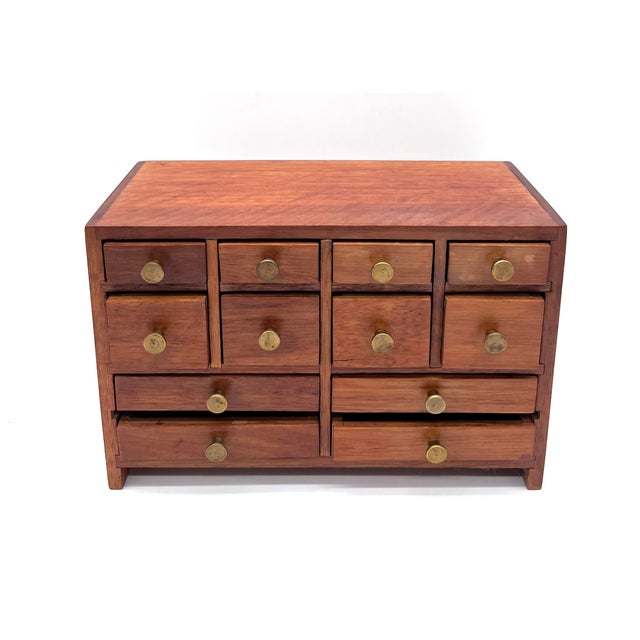 This exquisite miniature cabinet is an outstanding example of the functional yet elegant design of the Mid-Century Modern...