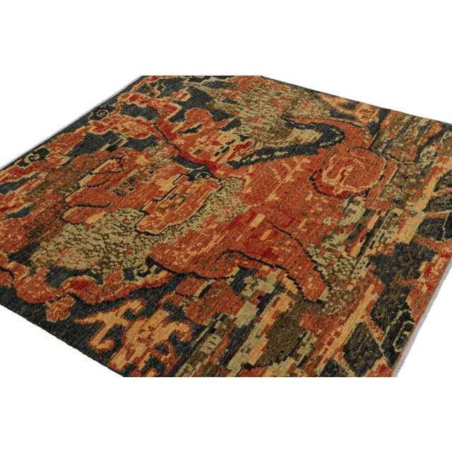 Hand-knotted in wool, this 6x6 square rug, originating from Afghanistan, features a dark blue field with warm fiery orange...