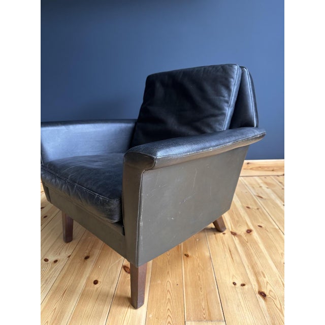 Danish Mid Century 1960's Black Leather Armchairs Introduce timeless Scandinavian elegance into your home with this...