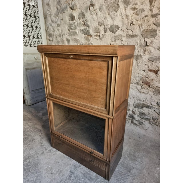 A vintage Globe Wernicke style drinks cabinet from France, dating from the 1960s. Made from mahogany, this elegant modular...
