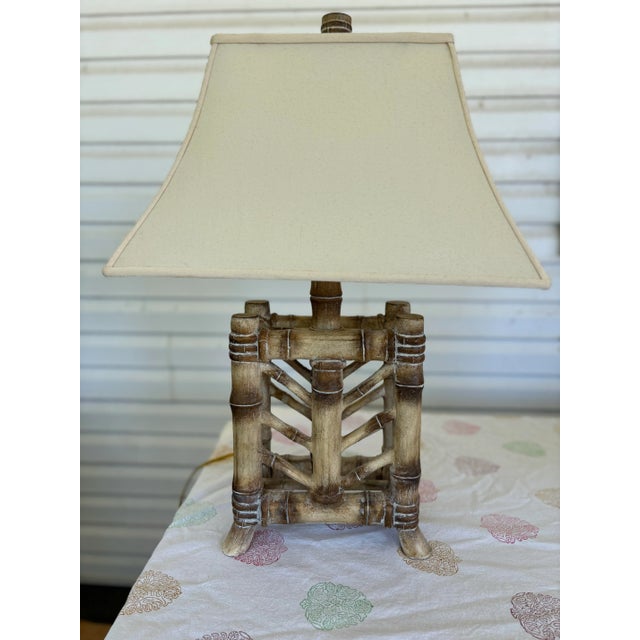 A striking pair of Pacific Coast Lighting faux bamboo table lamps featuring substantial architectural bases designed to...