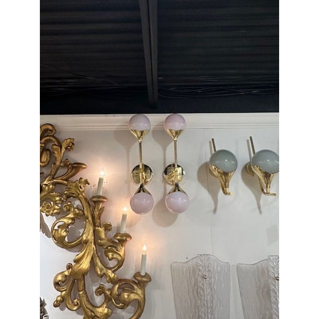 Decorative pair of modern pink pearl Murano glass sconces on a polished brass base. Very nice and can made in any color!