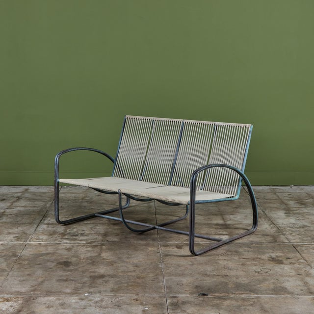 Bronze two seater settee by Walter Lamb for Brown Jordan. The settee has a beautiful curved construction in tubular bronze...