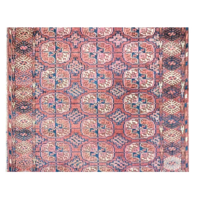 An early 20th century Turkmen Tekeh rug with an all-over pattern of multi-colored medallions, each with a stylized floral...
