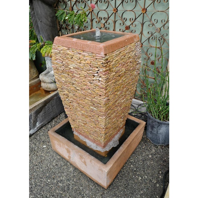 Beautiful stacked natural peach stone pebble fountain with square water basin. Wonderful addition and focal point to your...