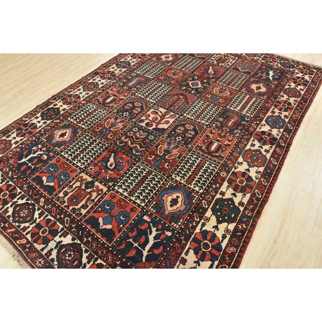 An authentic, semi-antique, traditional, tribal Bakhtiari rug hand-knotted with fine wool and natural dyes. This nomadic...