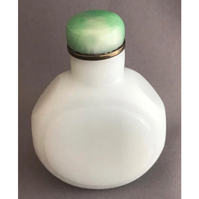 The opaline glass bottle with multifaceted sides served two purposes. The first one was to hold snuff ( residuals of the...