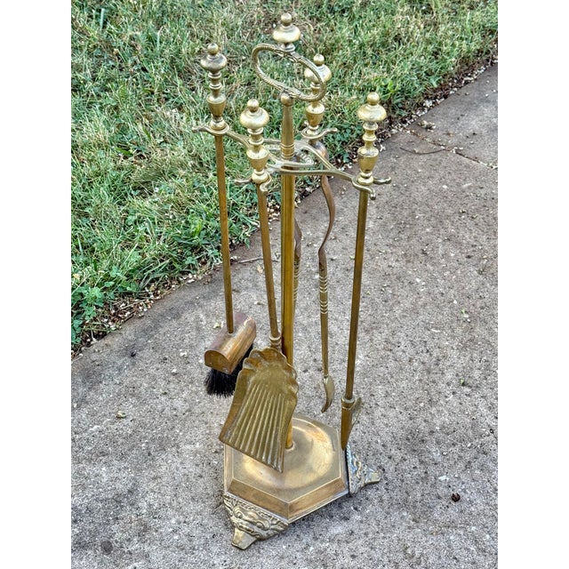 This complete set of Gothic 19th century brass fireplace tools includes a shovel, poke, tongs, and brush. Each tool is...