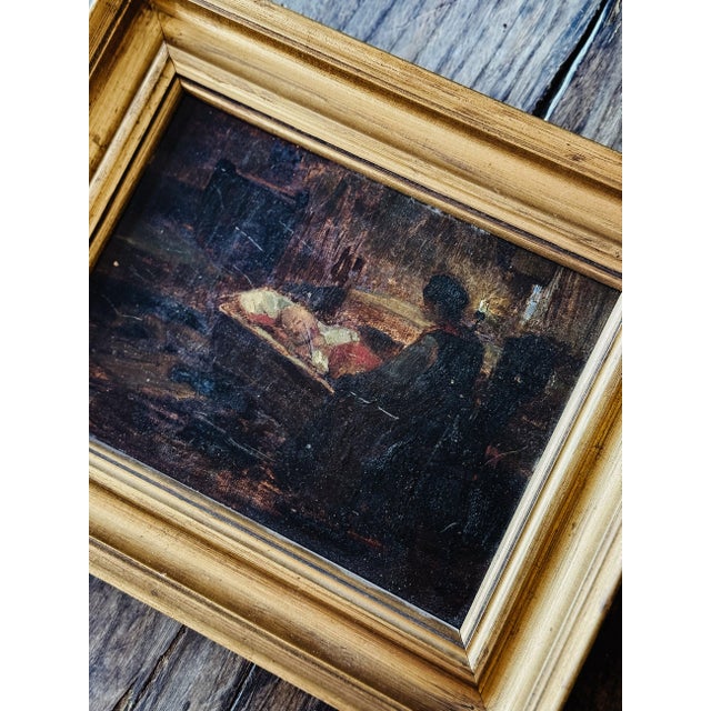 An incredible antique oil depicting a mother rocking a baby in a cradle to sleep in a dim candlelit room. The moody tones...