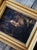An incredible antique oil depicting a mother rocking a baby in a cradle to sleep in a dim candlelit room. The moody tones...