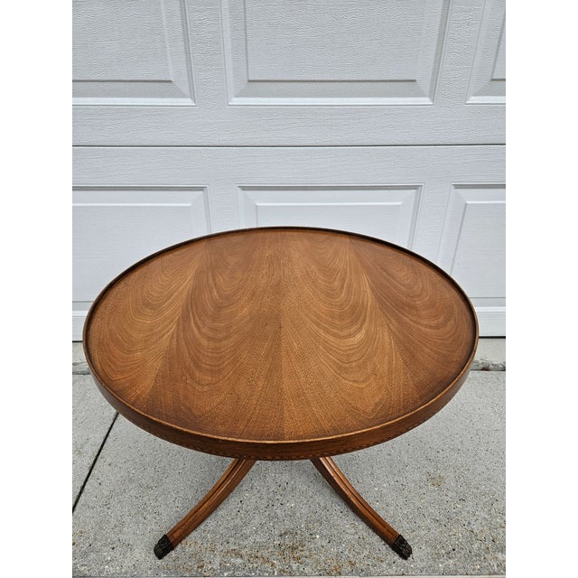 The woodgrain on this low round mahogany side table by Mersman is stunning! This piece features a tray lip and what...