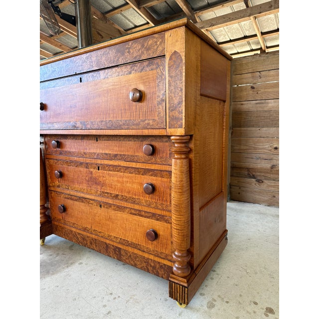 An exceptional American Empire chest of drawers showcasing richly figured tiger maple beautifully contrasted with striking...