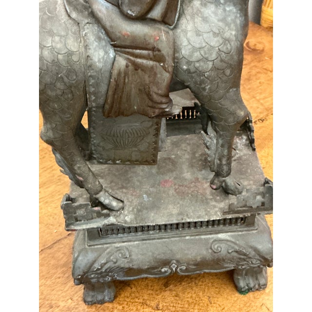 A captivating pair of vintage Asian statues, this set depicts serene immortals or scholars riding atop powerful, mythical...