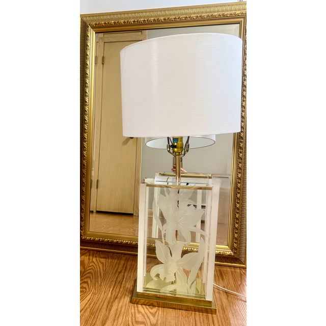 Vintage 1986s Fredrick Ramond Table LampDesign: Hollywood Regency style featuring a frosted glass column with a detailed,...