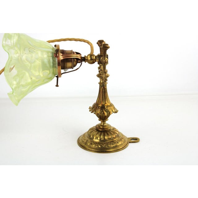 Brass base, umbrella made of light green opal glass, cabling renewed, swiveling arm, which means that the lamp can be used...
