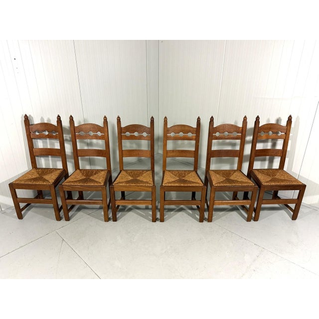Set of 6 rustic wooden dining chairs. Solid oak wood, very nice shaped razor high back rest, rush seat. 1960’s. In very...
