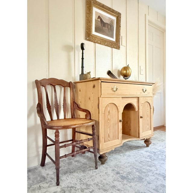 This charming antique sideboard cabinet is full of character and handcrafted detail. Made from solid pine with a warm,...