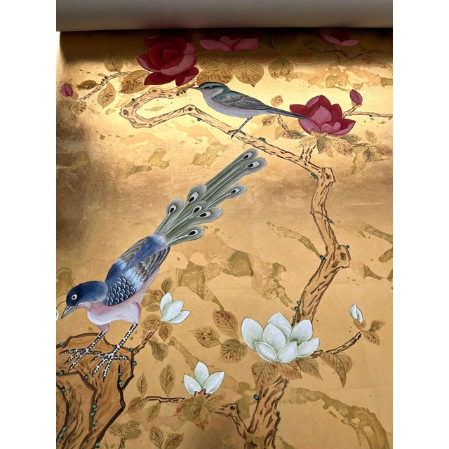 A luxurious hand painted gold leaf wallpaper featuring an exquisite chinoiserie scene with elegant birds, cranes,...